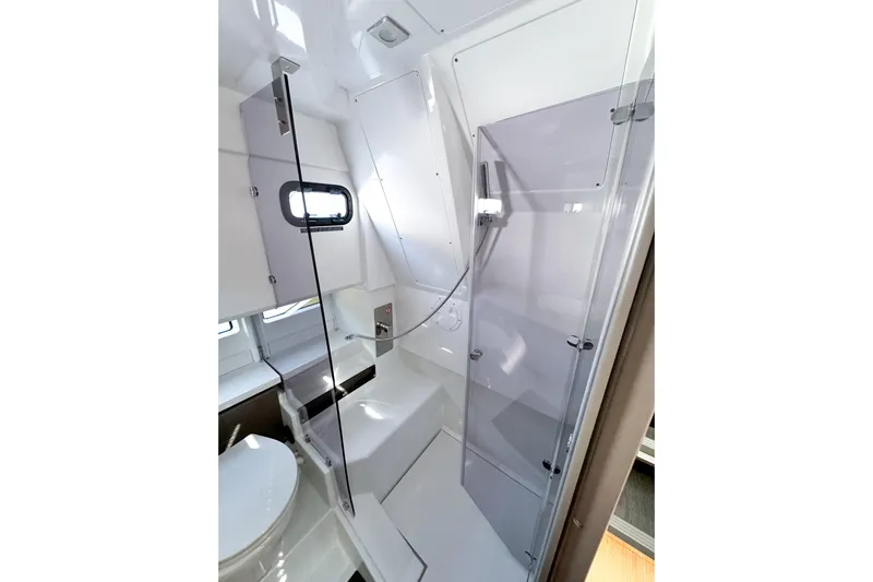  Yacht Photos Pics Modern bathroom interior of 2025 Wellcraft 38 Explorer yacht, featuring sleek design and glass shower.