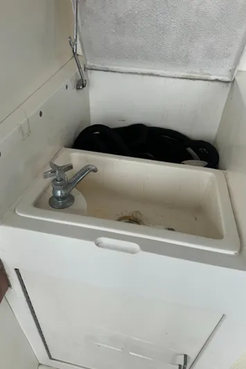 Half Fast Yacht Photos Pics 1992 Post 46 Sportfish boat sink with faucet and storage compartment.