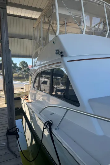 Half Fast Yacht Photos Pics 1992 Post 46 Sportfish boat docked under a covered marina.