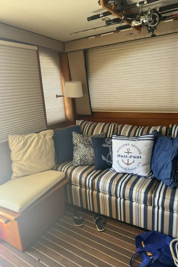 Half Fast Yacht Photos Pics Cozy interior of 1992 Post 46 Sportfish with striped sofa and nautical decor.