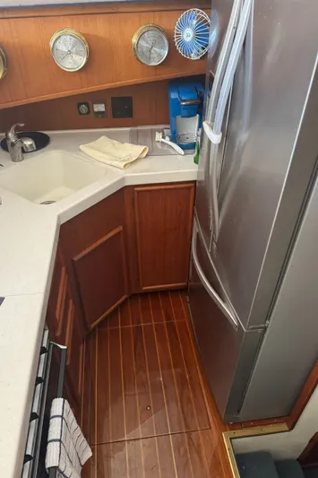 Half Fast Yacht Photos Pics 1992 Post 46 Sportfish yacht kitchen with wood flooring and modern appliances.