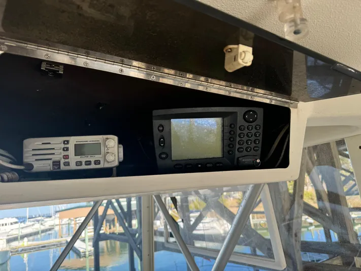 Half Fast Yacht Photos Pics 1992 Post 46 Sportfish boat electronics, featuring a navigation system and radio, dockside view.