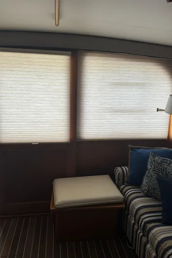 Half Fast Yacht Photos Pics Interior of 1992 Post 46 Sportfish yacht with striped sofa and window blinds.
