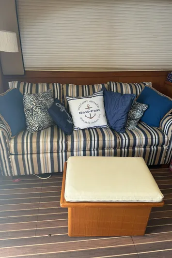 Half Fast Yacht Photos Pics Striped sofa with nautical-themed pillows on a 1992 Post 46 Sportfish boat interior.