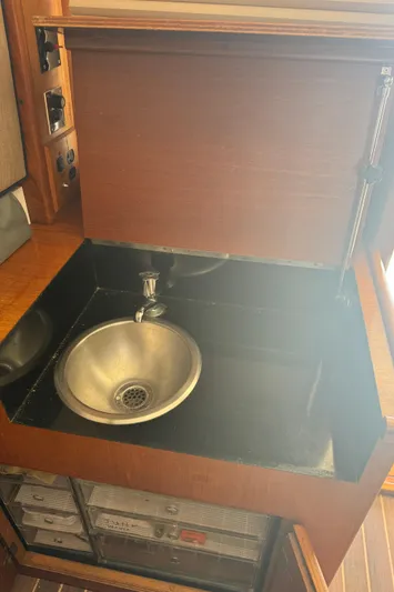 Half Fast Yacht Photos Pics 1992 Post 46 Sportfish yacht interior with stainless steel sink and wooden cabinetry.