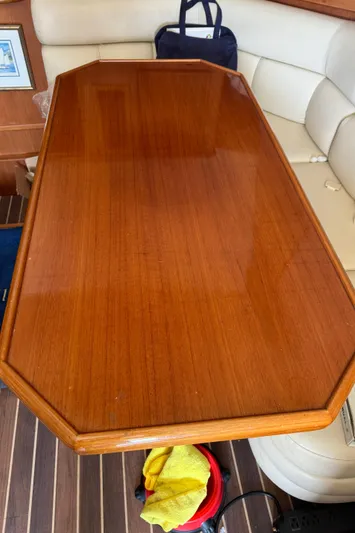 Half Fast Yacht Photos Pics Polished wooden table on 1992 Post 46 Sportfish yacht interior.