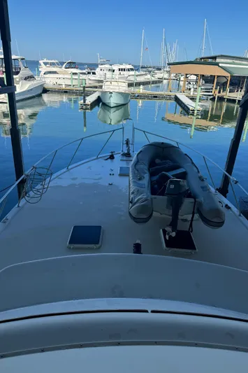 Half Fast Yacht Photos Pics 1992 Post 46 Sportfish boat docked at marina with inflatable dinghy on deck.
