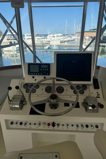 Half Fast Yacht Photos Pics Helm of 1992 Post 46 Sportfish boat with steering wheel and control panel.