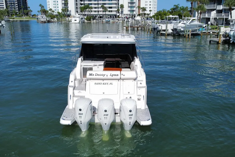  Yacht Photos Pics 2022 Regal 38 XO boat with triple outboard engines in a marina setting.