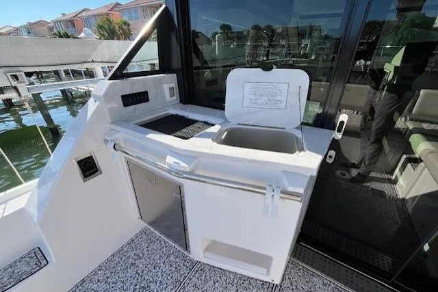  Yacht Photos Pics 2022 Regal 38 XO yacht kitchenette with sink and grill, dockside view.