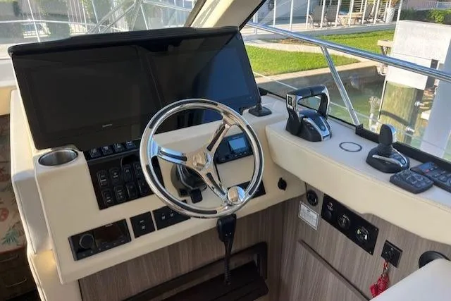  Yacht Photos Pics Helm of 2022 Regal 38 XO boat with modern controls and steering wheel.