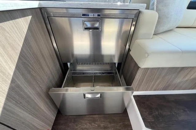  Yacht Photos Pics Stainless steel drawer in 2022 Regal 38 XO yacht interior, featuring modern wood paneling.