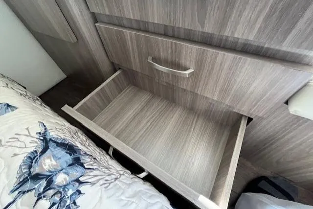  Yacht Photos Pics Empty wooden drawer in a 2022 Regal 38 XO boat interior.