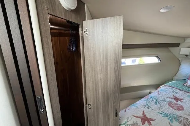  Yacht Photos Pics Interior cabin of 2022 Regal 38 XO yacht with open closet and bed.