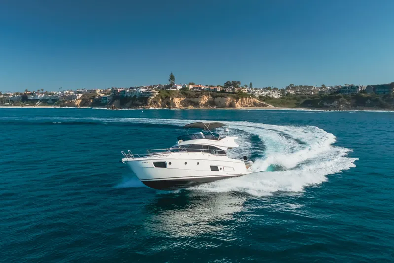 Special Place Yacht Photos Pics 2019 Bavaria Virtess 420 yacht cruising on blue ocean near scenic coastline.