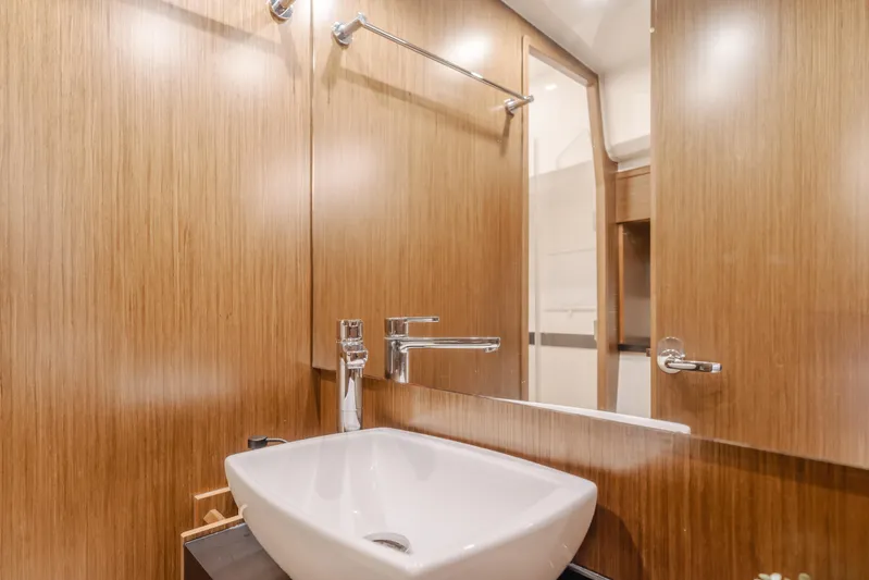 Special Place Yacht Photos Pics Luxurious bathroom interior of 2019 Bavaria Virtess 420 yacht with modern sink and wooden finish.