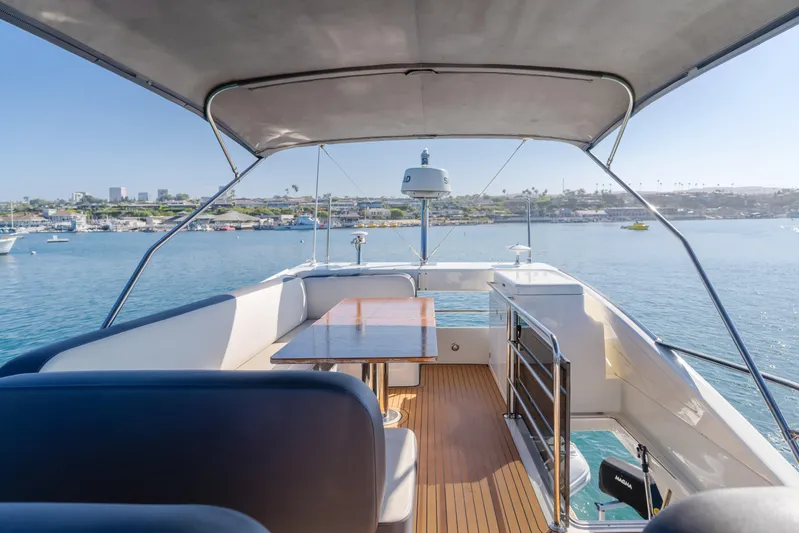 Special Place Yacht Photos Pics Flybridge view of 2019 Bavaria Virtess 420 yacht with seating and table, overlooking serene waters.