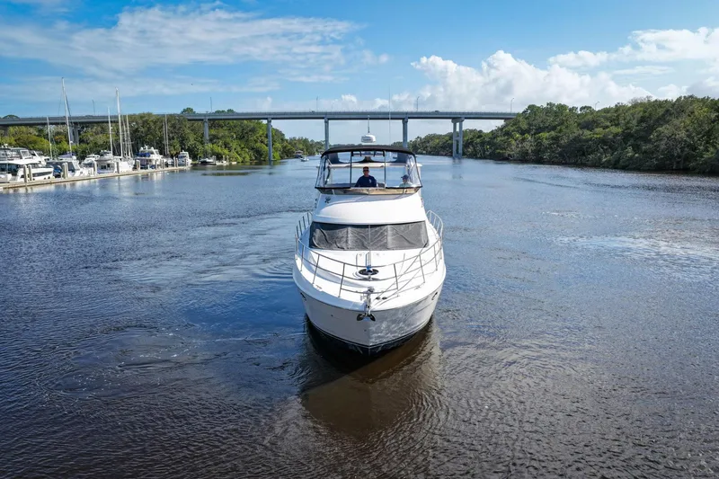 Bella Vita Yacht Photos Pics 2008 Meridian 408 Motoryacht cruising on a scenic river under a blue sky.