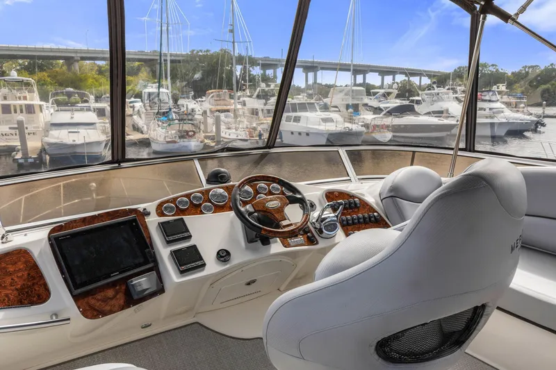Bella Vita Yacht Photos Pics Helm of 2008 Meridian 408 Motoryacht overlooking marina with multiple boats docked.