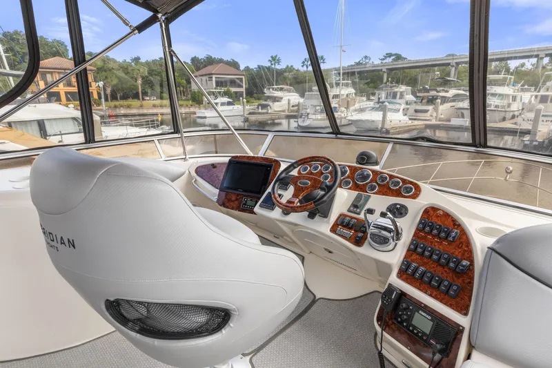 Bella Vita Yacht Photos Pics 2008 Meridian 408 Motoryacht helm with luxurious controls and marina view.