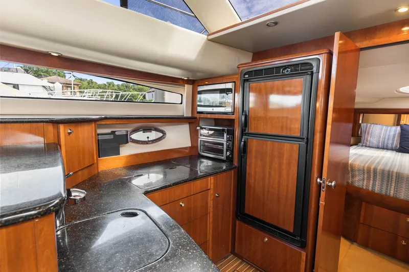 Bella Vita Yacht Photos Pics Luxurious 2008 Meridian 408 Motoryacht interior with modern kitchen and cozy bedroom.