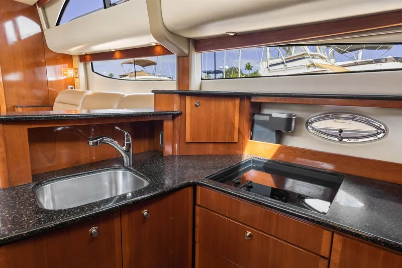 Bella Vita Yacht Photos Pics Luxurious kitchen interior of 2008 Meridian 408 Motoryacht with sleek wood cabinetry.