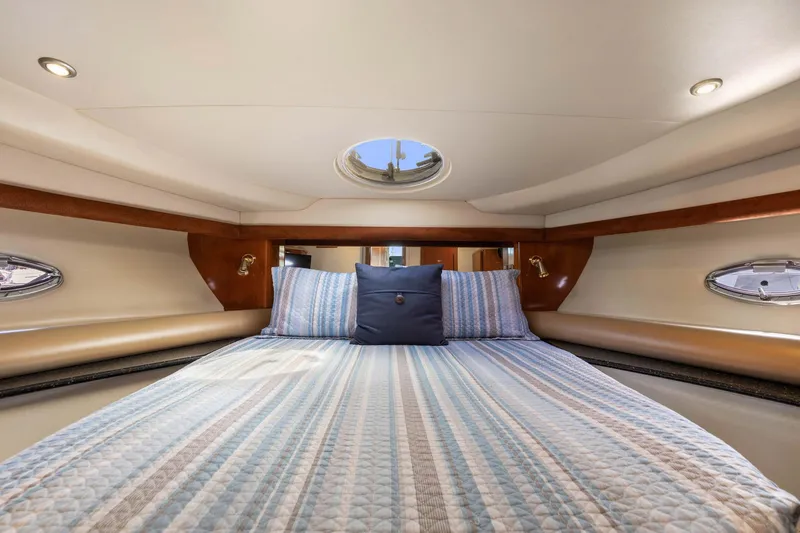 Bella Vita Yacht Photos Pics Luxurious cabin interior of 2008 Meridian 408 Motoryacht with cozy bedding and porthole windows.