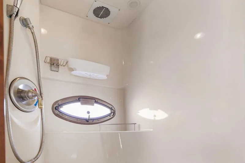Bella Vita Yacht Photos Pics Shower area in 2008 Meridian 408 Motoryacht with porthole and modern fixtures.