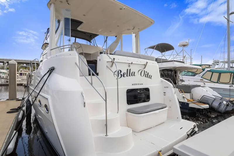 Bella Vita Yacht Photos Pics 2008 Meridian 408 Motoryacht docked, featuring "Bella Vita" on the stern, under a clear blue sky.