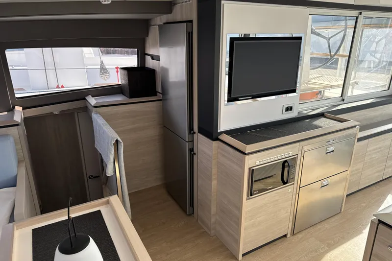Alter Ego Yacht Photos Pics Modern interior of 2023 Catana 50 Ocean Class yacht with sleek kitchen and entertainment area.