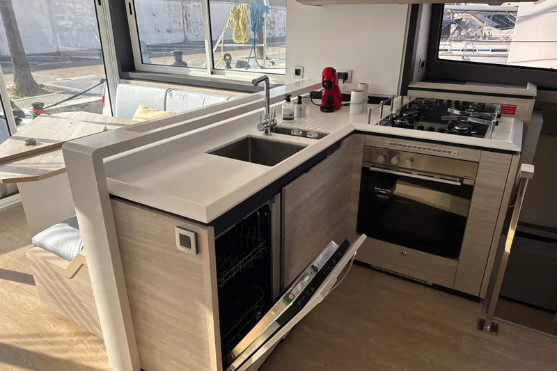 Alter Ego Yacht Photos Pics Modern kitchen in 2023 Catana 50 Ocean Class yacht with stove, sink, and dishwasher.