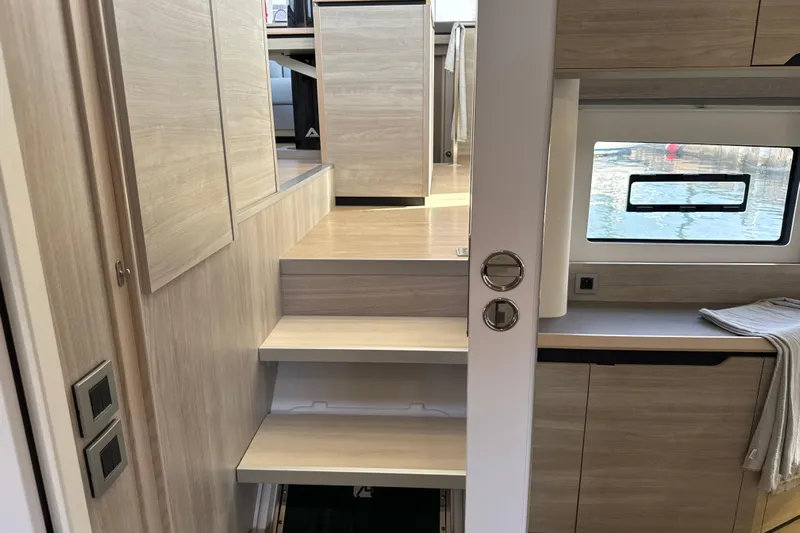 Alter Ego Yacht Photos Pics Interior of 2023 Catana 50 Ocean Class yacht with modern wooden stairs and window view.