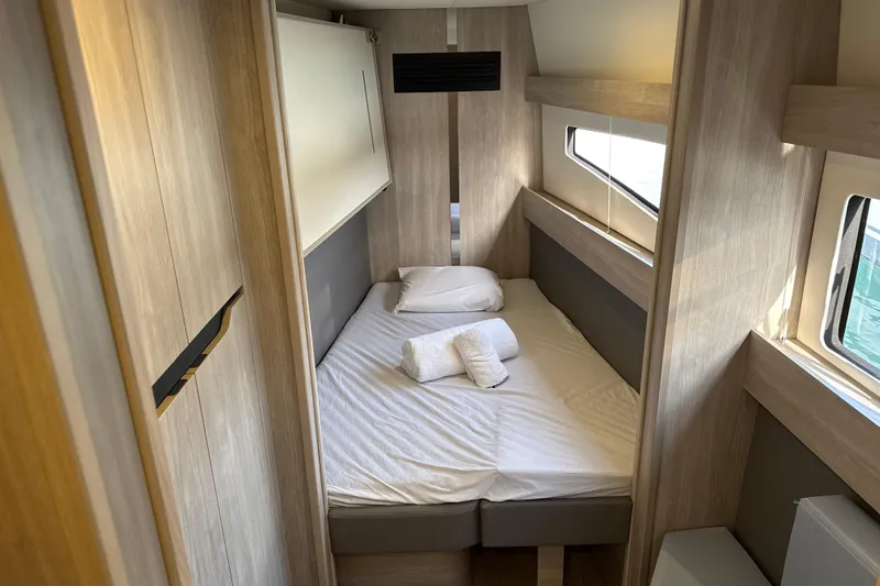 Alter Ego Yacht Photos Pics Luxurious cabin interior of 2023 Catana 50 Ocean Class yacht, featuring a cozy bed and modern design.