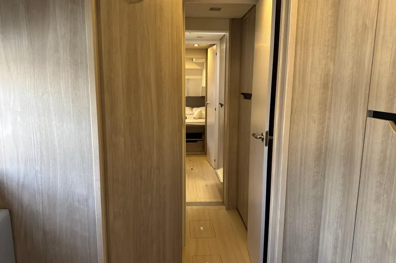 Alter Ego Yacht Photos Pics Interior hallway of 2023 Catana 50 Ocean Class yacht, featuring modern wood paneling.