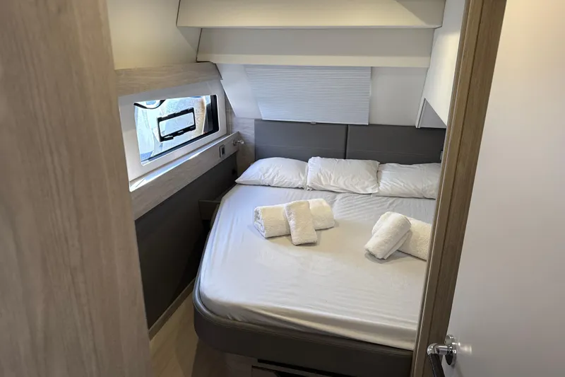 Alter Ego Yacht Photos Pics Luxurious bedroom in 2023 Catana 50 Ocean Class yacht with cozy bedding and window view.