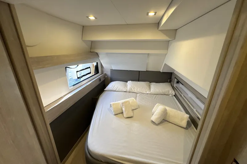 Alter Ego Yacht Photos Pics Luxurious bedroom interior of 2023 Catana 50 Ocean Class yacht with cozy bedding.
