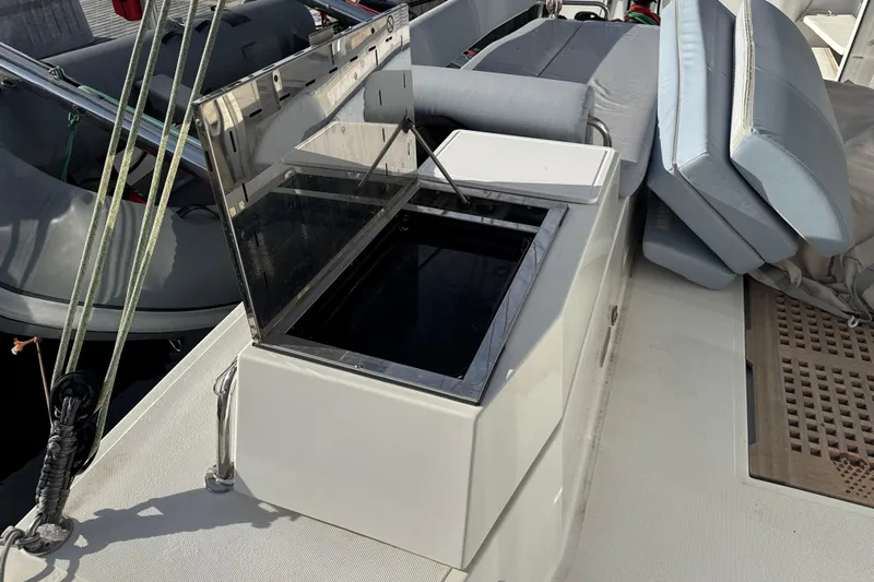Alter Ego Yacht Photos Pics 2023 Catana 50 Ocean Class yacht deck with open storage compartment and cushions.