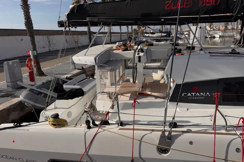 Alter Ego Yacht Photos Pics 2023 Catana 50 Ocean Class catamaran docked at marina, showcasing sleek design and spacious deck.
