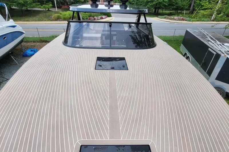  Yacht Photos Pics 2023 VanDutch 56 yacht with sleek, modern deck design and panoramic windshield.