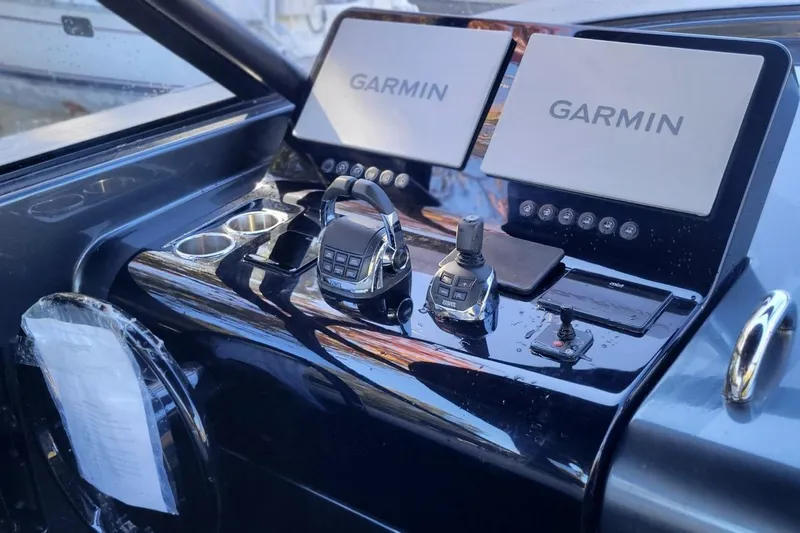  Yacht Photos Pics Control panel of 2023 VanDutch 56 yacht with dual Garmin displays and navigation controls.