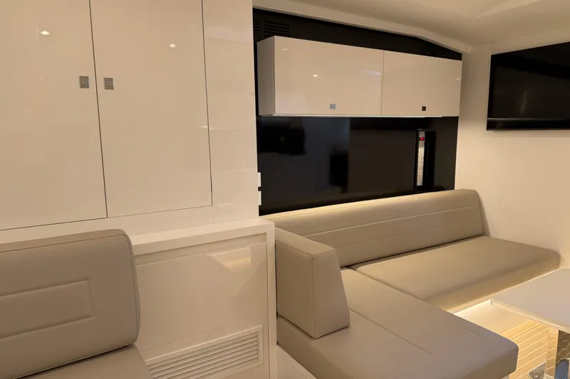  Yacht Photos Pics Luxurious interior of 2023 VanDutch 56 yacht with sleek seating and modern cabinetry.