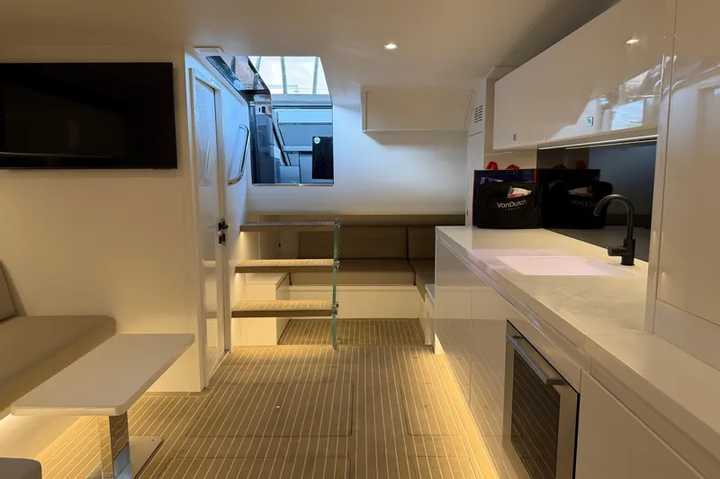  Yacht Photos Pics Luxurious interior of 2023 VanDutch 56 yacht with modern kitchen and seating area.