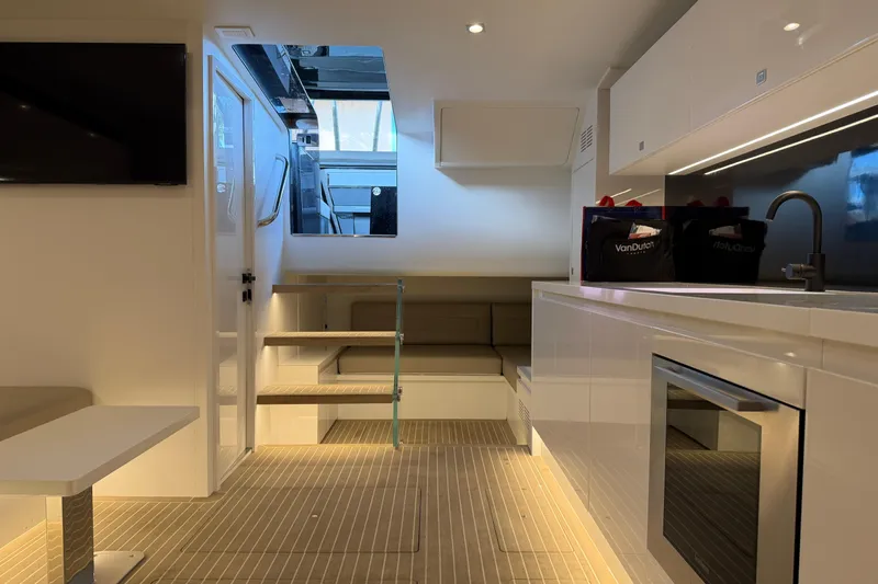  Yacht Photos Pics Luxurious interior of 2023 VanDutch 56 yacht with modern kitchen and seating area.