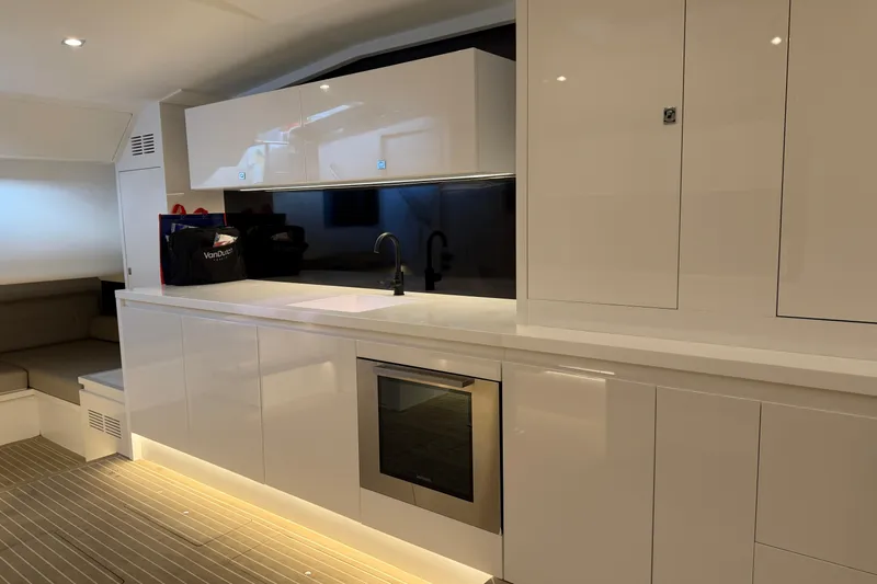  Yacht Photos Pics Luxurious interior of 2023 VanDutch 56 yacht with modern kitchen design.