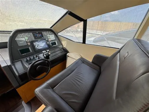  Yacht Photos Pics 2008 Pershing 64' yacht helm station with leather captain's chair and advanced navigation controls.