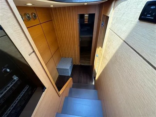  Yacht Photos Pics Interior stairway of 2008 Pershing 64' yacht with modern wood paneling.