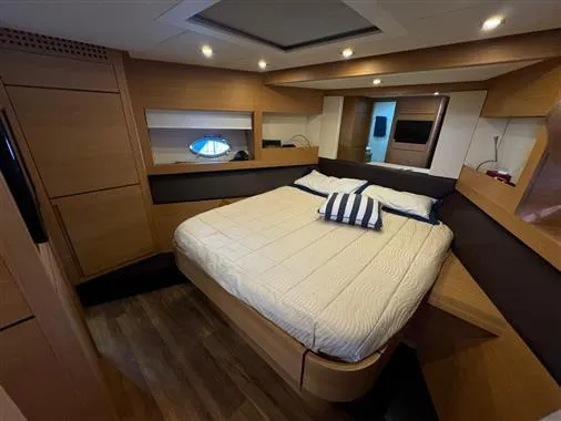  Yacht Photos Pics Luxurious bedroom interior of 2008 Pershing 64' yacht with modern wood finishes.