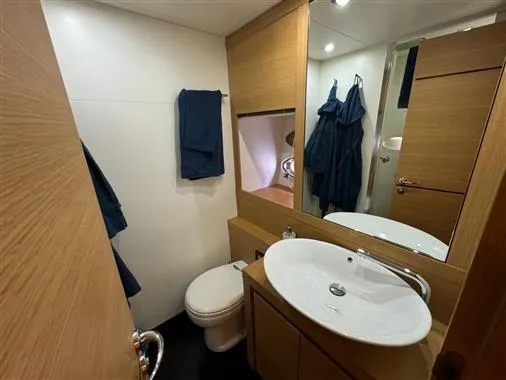  Yacht Photos Pics 2008 Pershing 64' yacht bathroom with modern fixtures and wooden cabinetry.