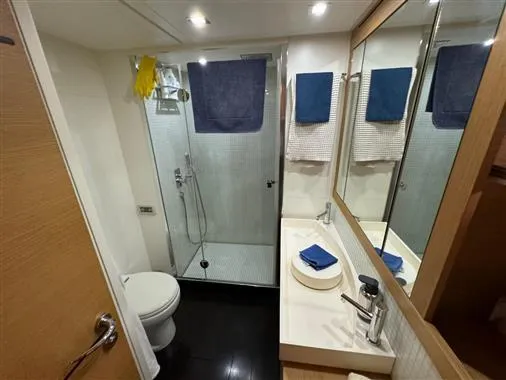  Yacht Photos Pics Modern bathroom in a 2008 Pershing 64' yacht with shower, sink, and toilet.
