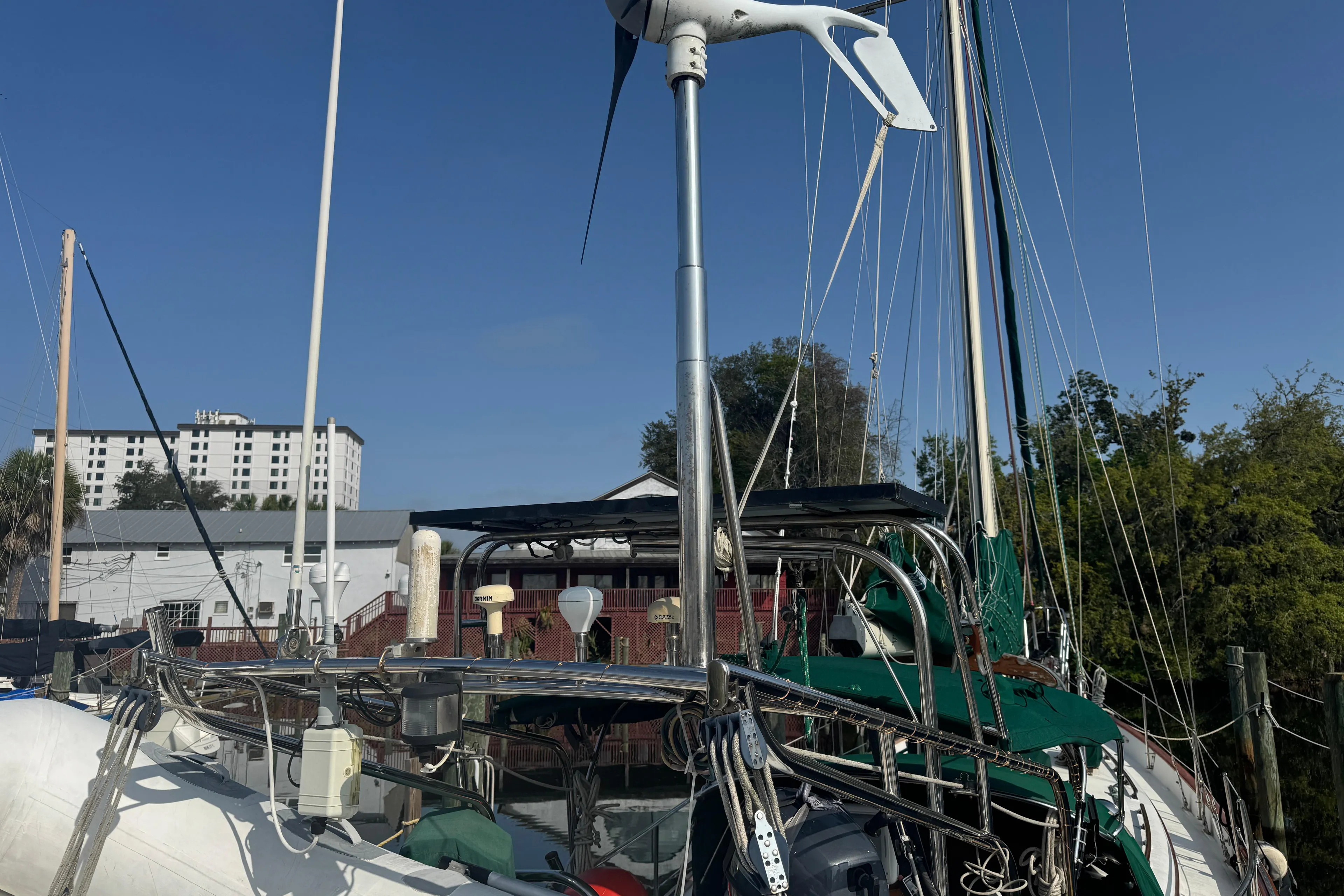 Sailboat Hans Christian 43T, 1989 model, docked with visible wind turbine and rigging.